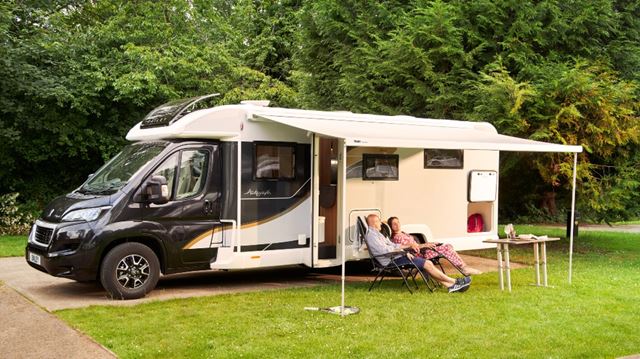 People relaxing outside caravan header